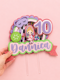 Personalized spa day birthday cake topper featuring custom name and age with layered cardstock design, shaker elements, spa-themed decorations, and acrylic cake stakes.